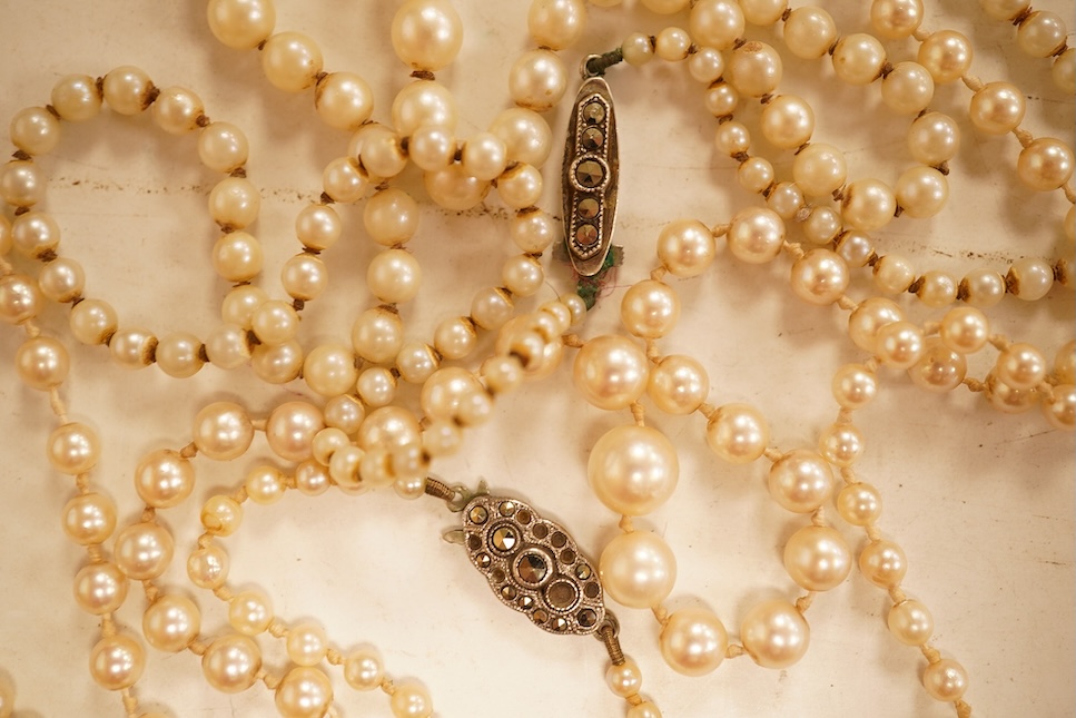 Two single strands graduated cultured pearl necklaces, both with marcasite set sterling clasps, longest, 64cm.